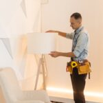 Male Electrician Repairing Light floor lamp