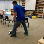 Professional cleaner working at office vacuuming floors